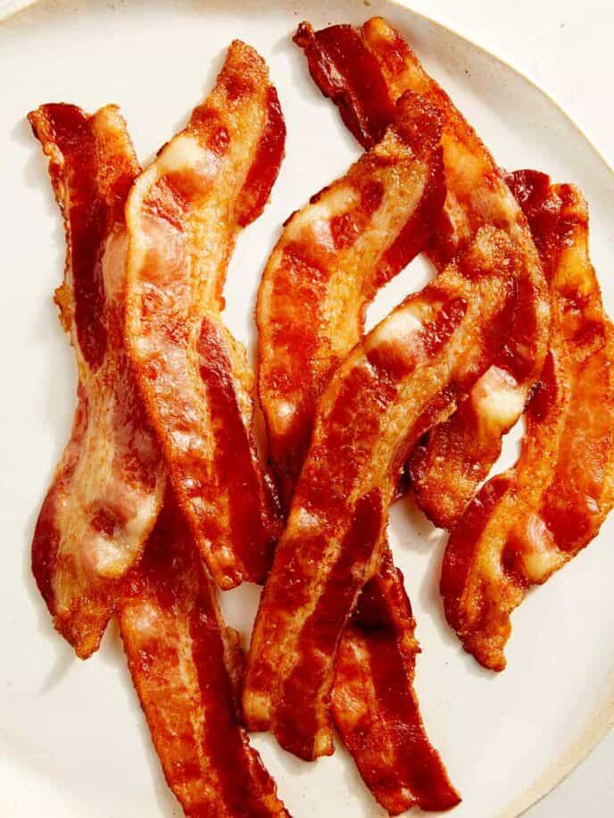 Cooked bacon on a platter ready to be served.