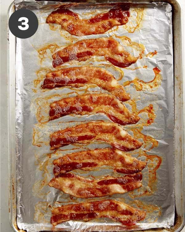 Bacon cooked on a backing sheet lined with foil. 
