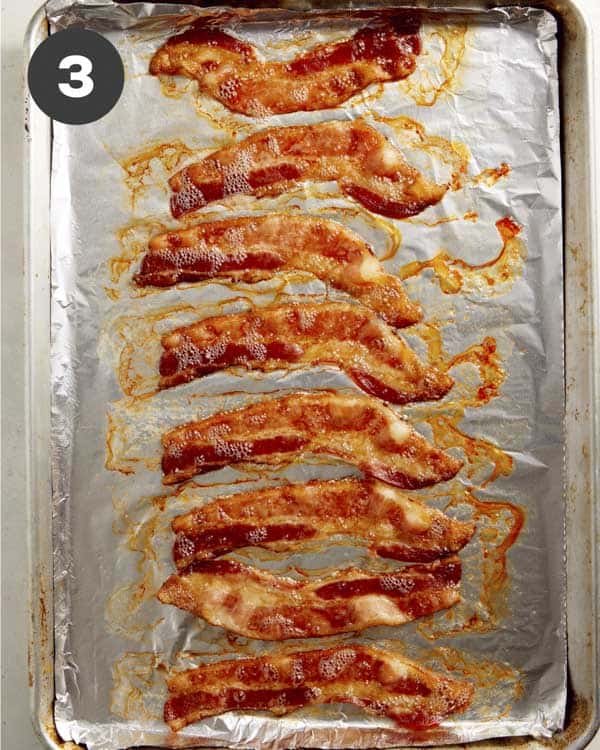 Bacon cooked on a backing sheet lined with foil.