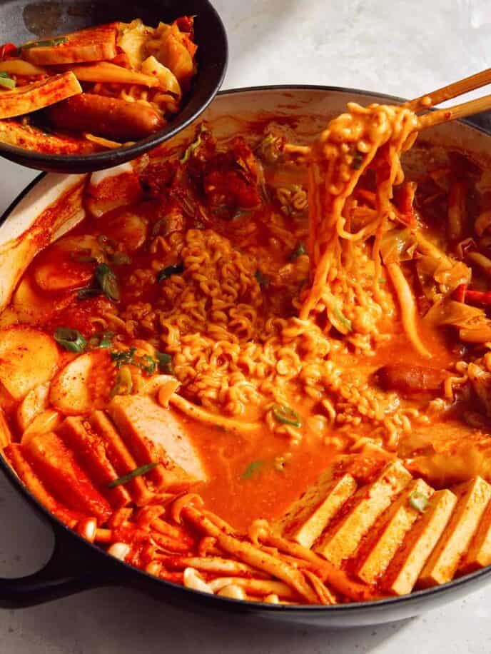 Budae Jjigae being served into bowls.