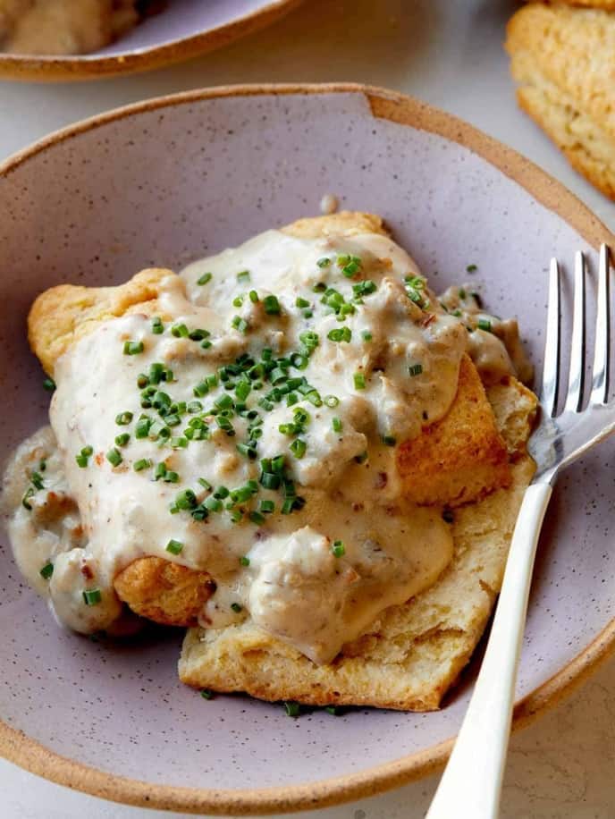 biscuits and gravy in a bowl with a fork