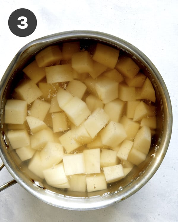 Potatoes being boiled in a pot.