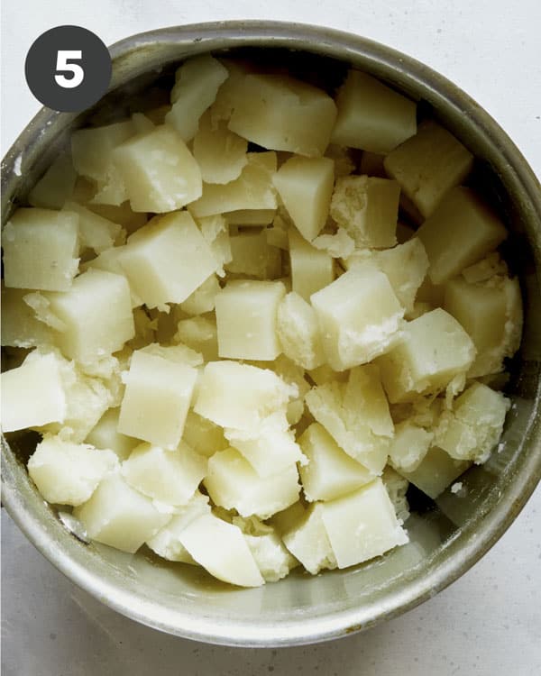 Cooked potatoes in a pot to make Colcannon.