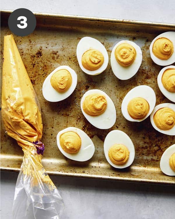 Deviled eggs being made and filled.