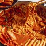 Budae Jjigae being served into bowls.