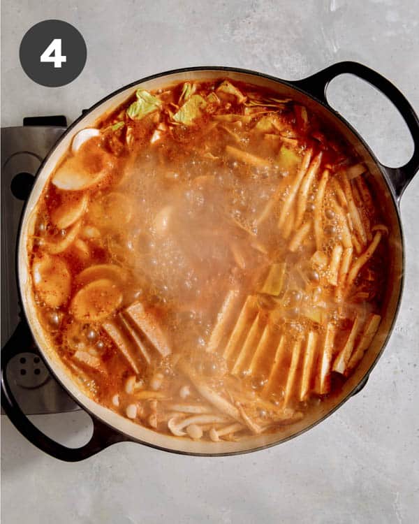 Korean Army Stew simmering in a skillet. 