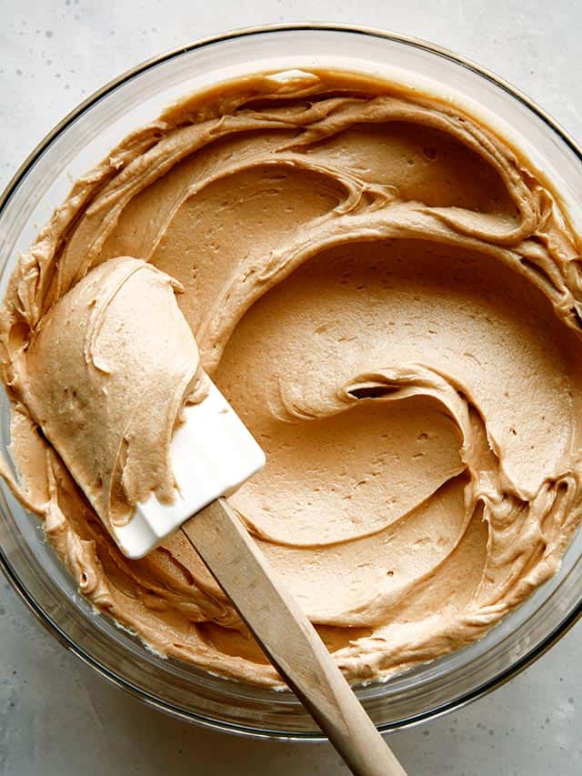 peanut butter frosting with a plastic spoon