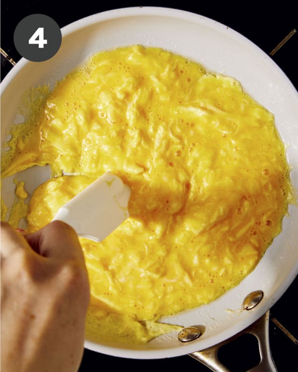 Eggs being cooked in a skillet. 