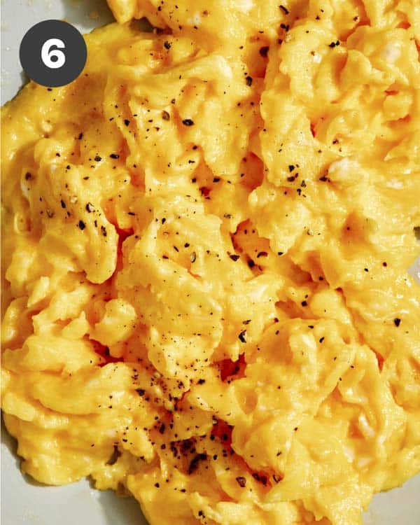 Scrambled eggs with salt and pepper on top.