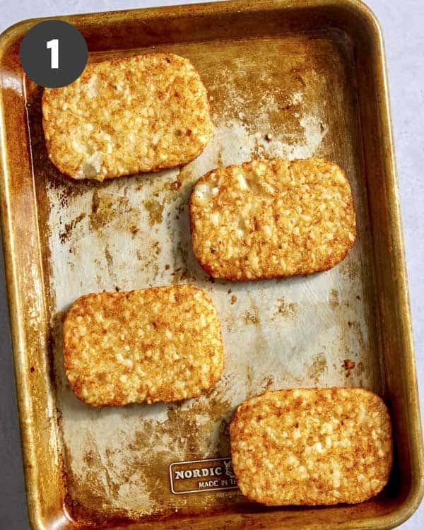 Hash browns on a baking sheeting after they have cooked.