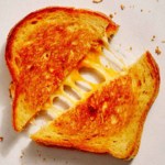 Grilled cheese cut in half.