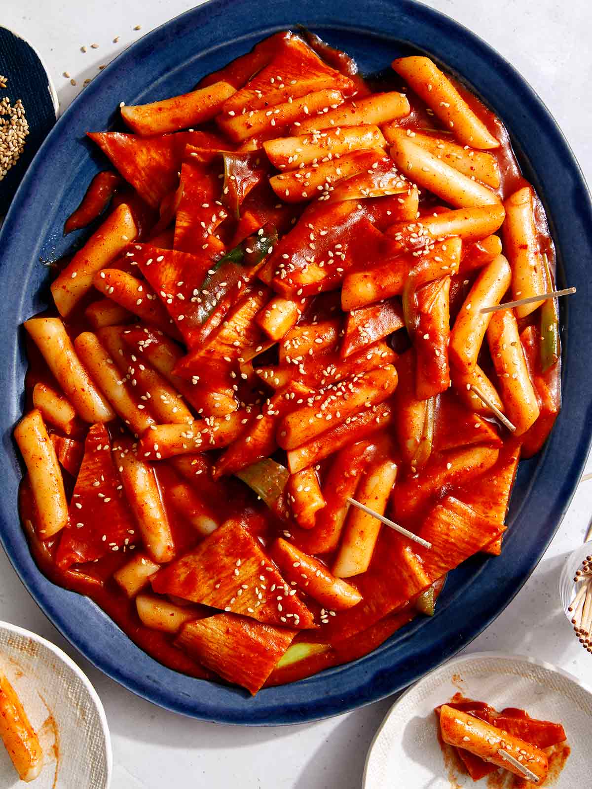 Tteokbokki, Korean rice cakes, recipe on a platter being served. 