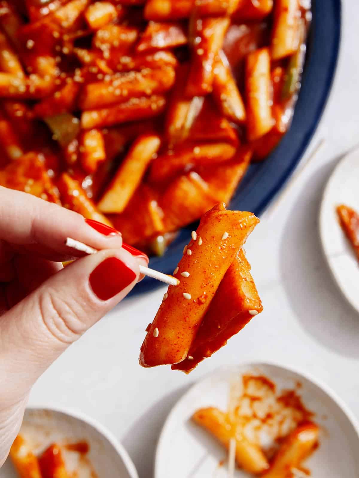 Tteokbokki recipe served with toothpicks.