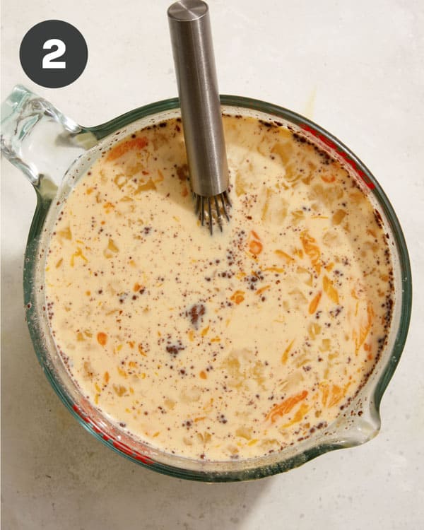An egg mixture whisked together in a large measuring cup.