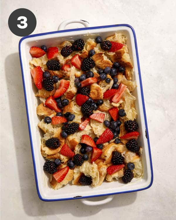 Croissants and berries in a baking dish. 