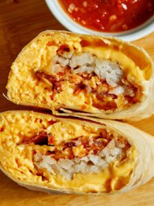 Breakfast Burrito cut in half to show all the ingredients.