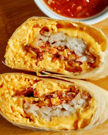 Breakfast Burrito cut in half to show all the ingredients.