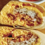 Breakfast burrito cut in half with salsa on the side.