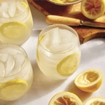 Lemonade in a glass with lemon wheels.