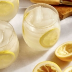 Classic lemonade recipe in glasses with ingredients around the side.