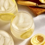 Classic lemonade recipe in glasses with ingredients around the side.