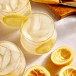 Lemonade in a glass with lemon wheels.
