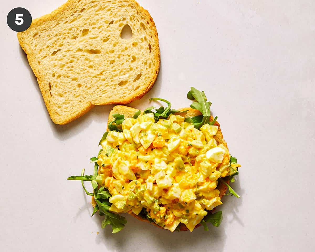 Egg salad sandwich in the process of being made. 