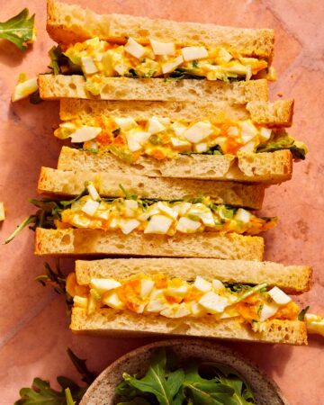 Egg salad sandwich recipe on a surface.