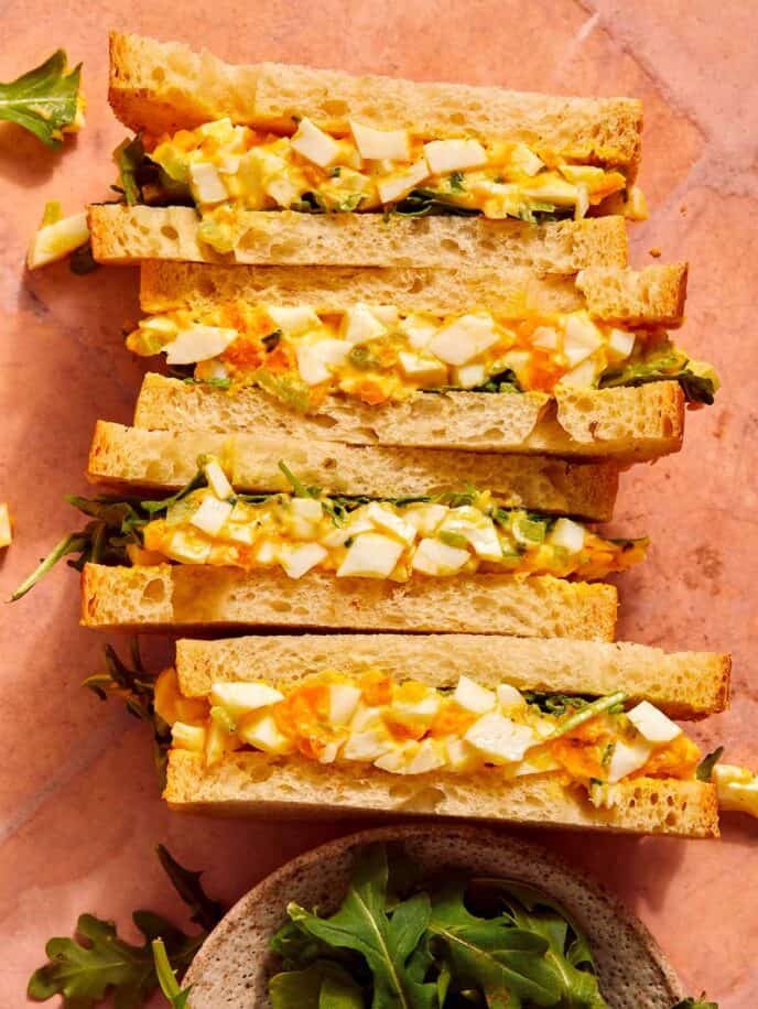 Egg salad sandwich recipe on a surface.