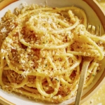 Lemon pasta in a bowl with breadcrumbs on top.