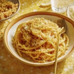 Lemon pasta in a bowl with breadcrumbs on top.
