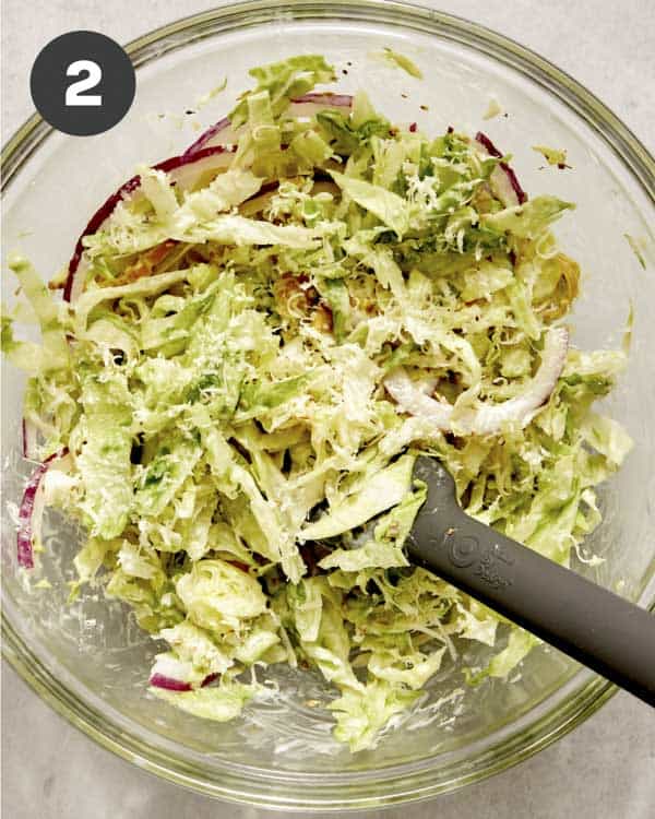 Grinder sandwich slaw in a bowl being mixed together. 