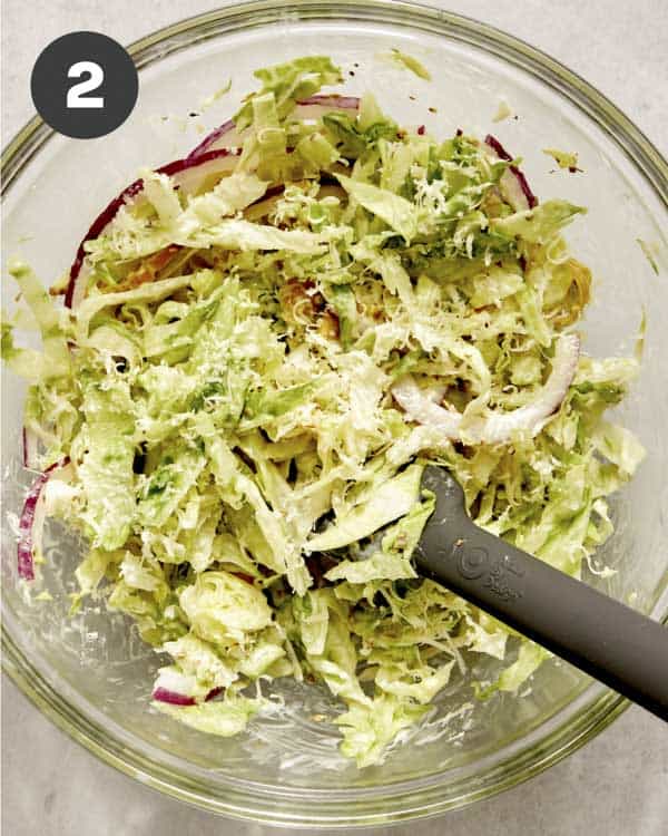 Grinder sandwich slaw in a bowl being mixed together.