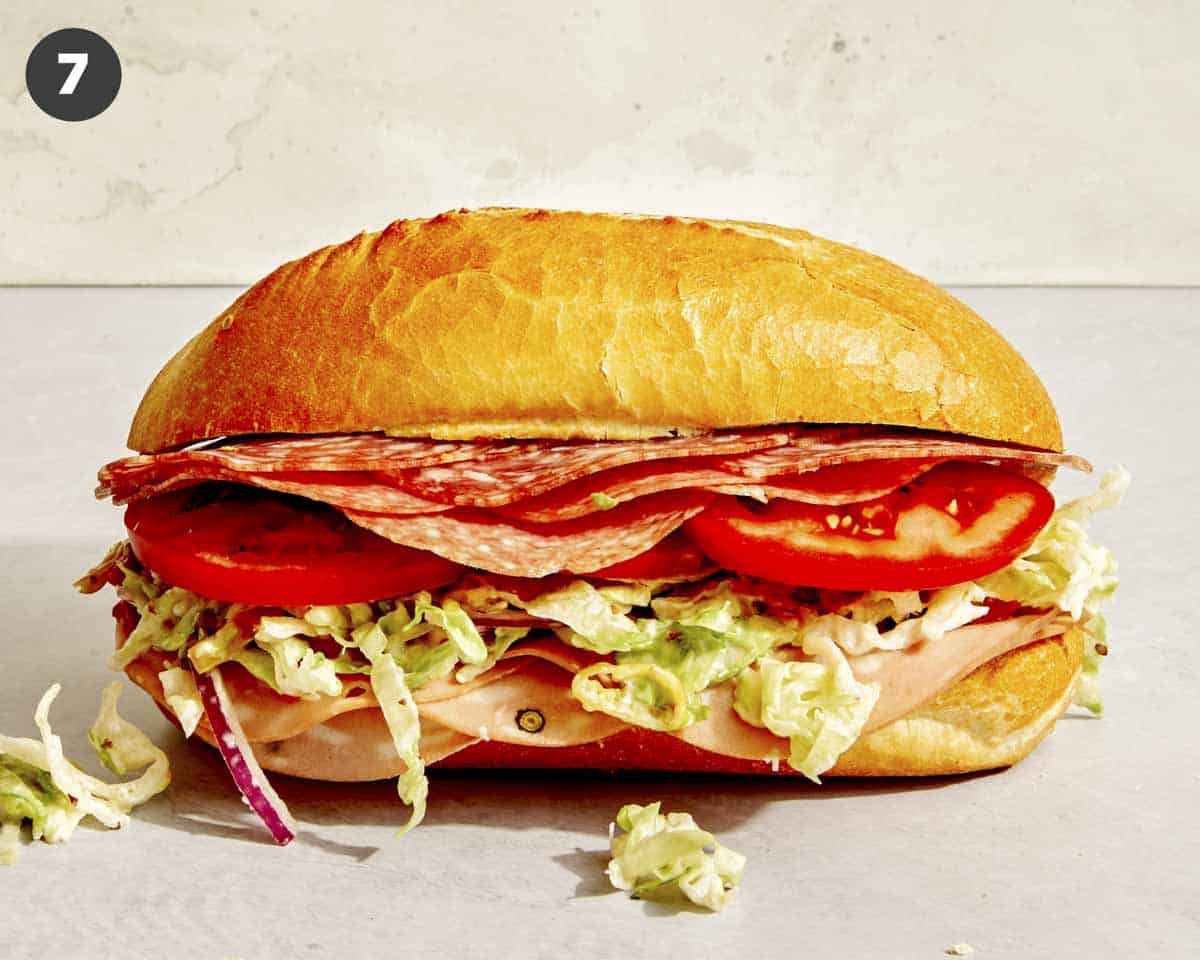 A grinder sandwich freshly made on a surface.