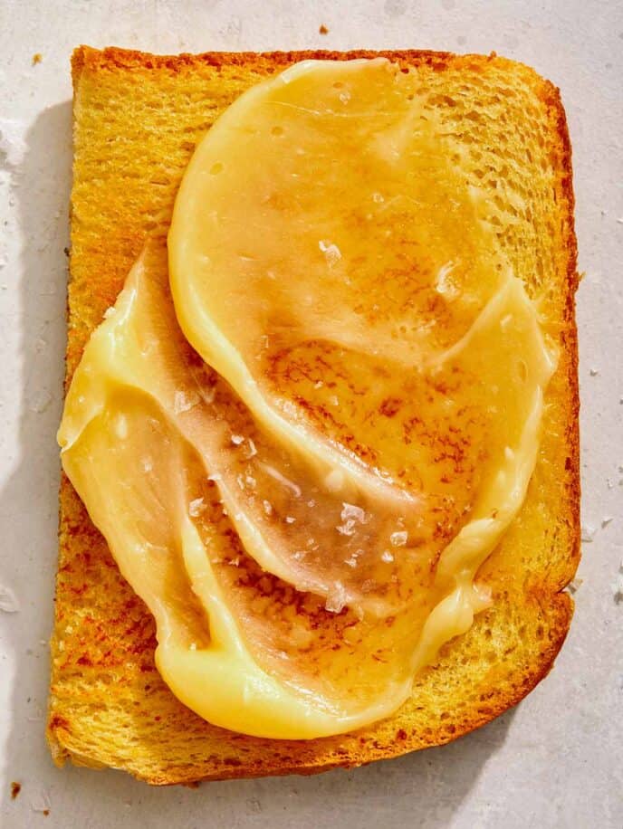 Honey butter on toast with salt on top.