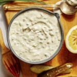 Tartar sauce recipe in a bowl with ingredients on the side.