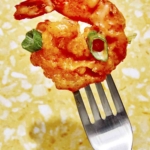 Bang bang shrimp on a fork ready to eat.