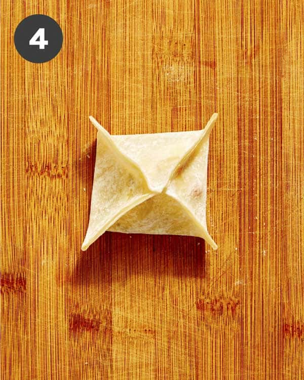 A freshly pleated crab rangoon ready to be cooked.