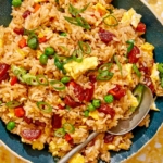 Fried rice in a bowl with green onions on the side.