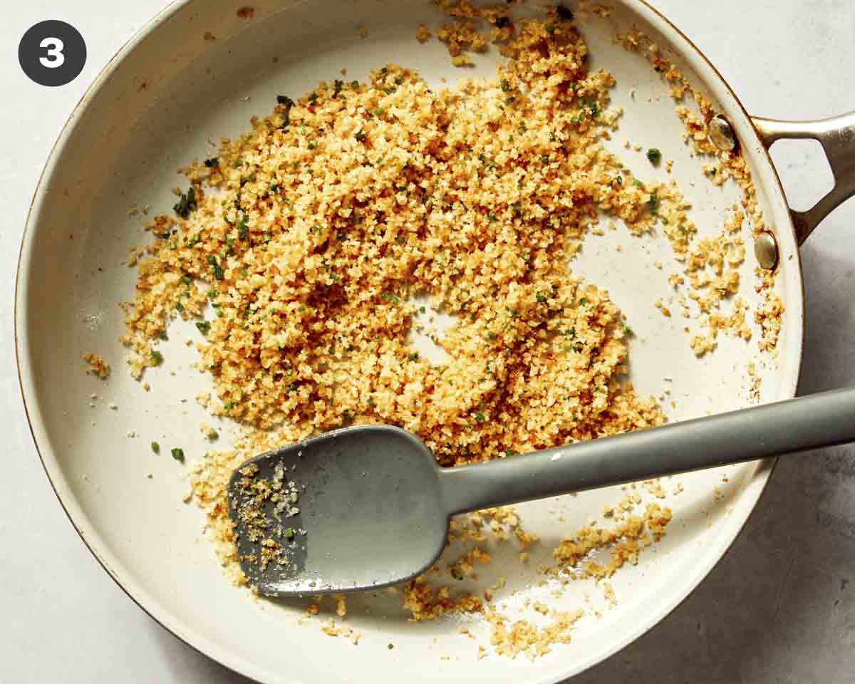 Breadcrumbs with chives in a skillet tp sprinkle over lemon pasta.