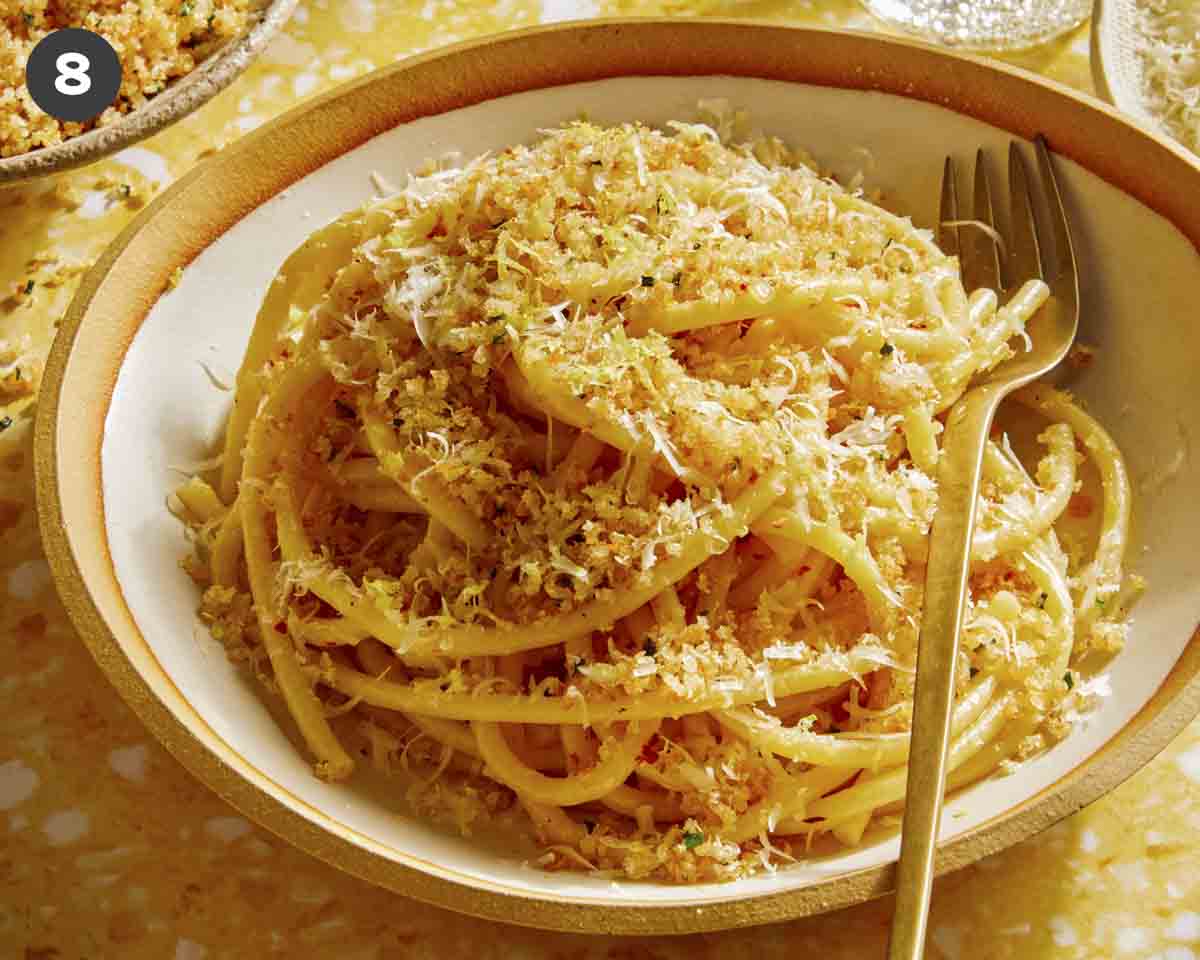 Lemon pasta in a bowl with breadcrumbs on top. 