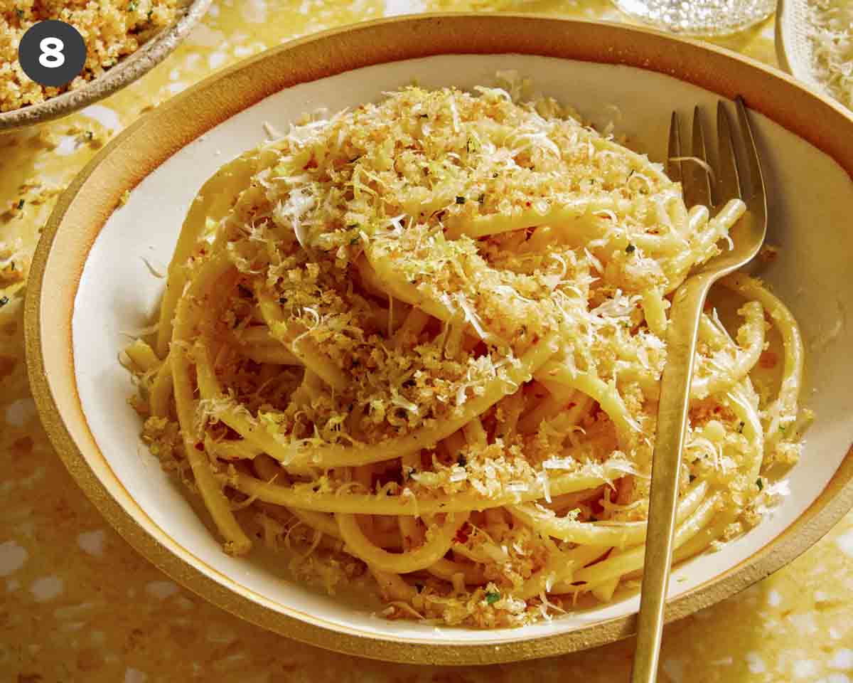 Lemon pasta in a bowl with breadcrumbs on top.