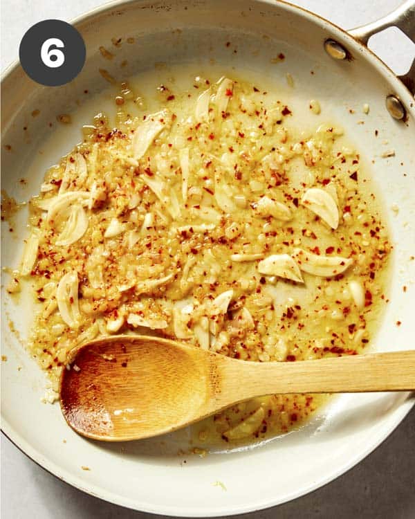 Pasta sauce for lemon pasta cooking in a skillet.