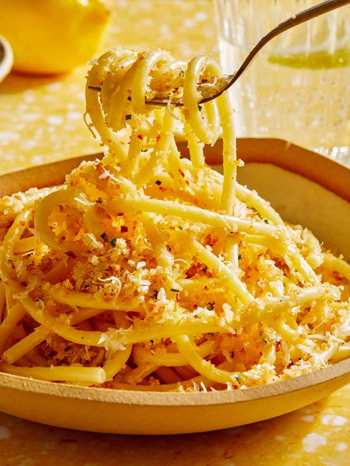 Garlic lemon pasta being eaten with a fork.