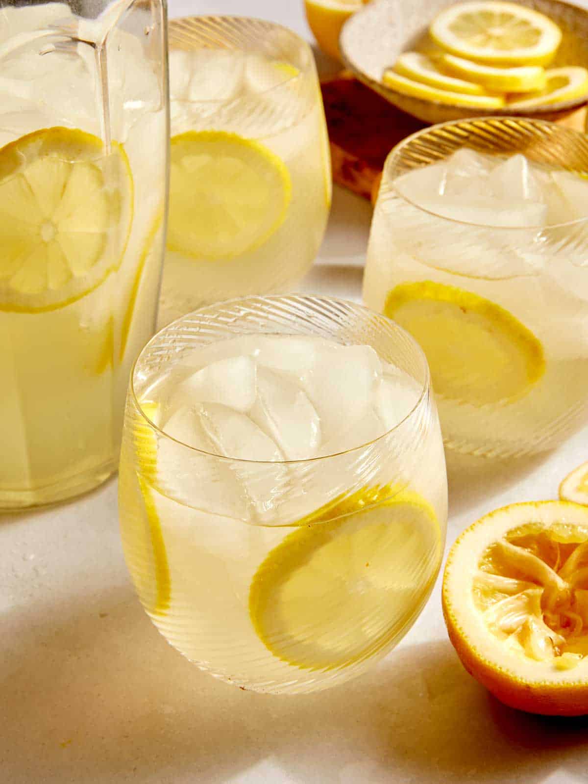 Lemonade in a glass with lemon wheels.
