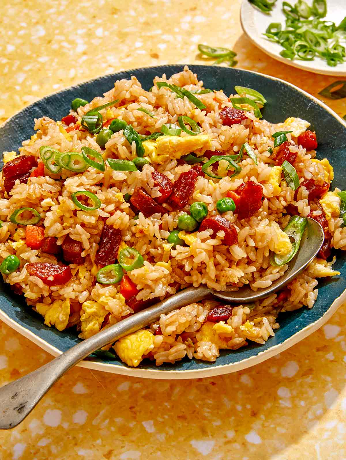 Fried rice in a bowl with a spoon in it.