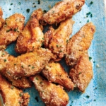 Parmesan chicken wings made in the air fryer on a platter.