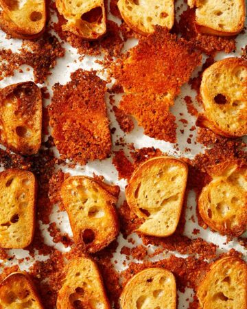 Parmesan crusted crostini in a baking dish.