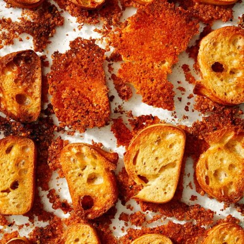 Parmesan crusted crostini in a baking dish.