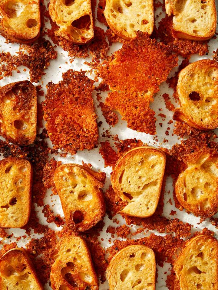 Parmesan crusted crostini in a baking dish.